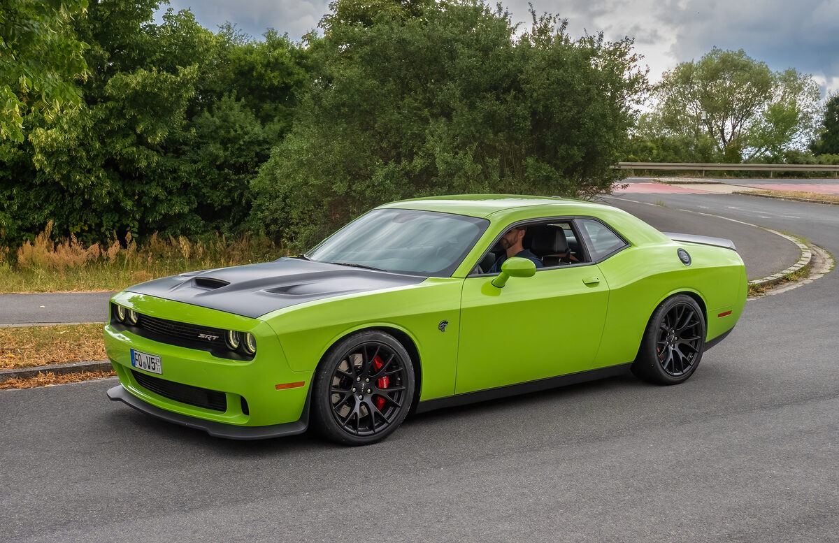 Green Dodge Challenger SRT on a quiet road